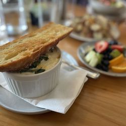 Chez Genèse - Tomato basil ricotta Cocotte served with baguette and fruit