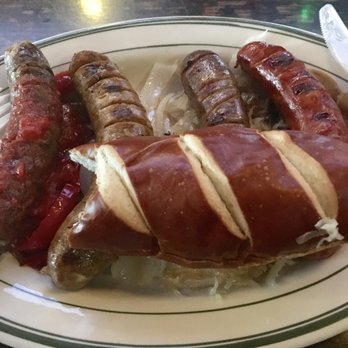 Knight's Bar At Maders - Sausage Sampler with Pretzel bun and Kraut! - German Near Me - Milwaukee, Wisconsin Knight's Bar At Maders - Sausage Sampler with Pretzel bun and Kraut! - German Near Me - Milwaukee, Wisconsin
