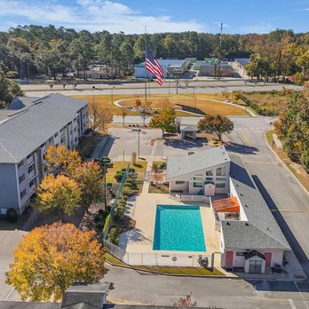 Plantation Oaks Apartments - An aerial view of a school with a pool and a flag - Apartments Near Me - Savannah, Georgia Plantation Oaks Apartments - An aerial view of a school with a pool and a flag - Apartments Near Me - Savannah, Georgia