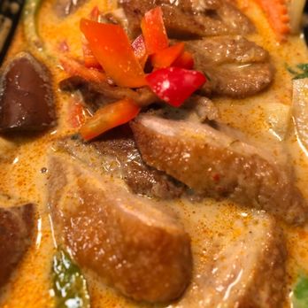 Thai Cafe 88 - Red Curry w/ Crispy Duck - A close-up of a Thai red curry dish featuring crispy duck pieces, red peppers, and vegetables in a creamy, spicy sauce. - Thai Near Me - Garnerville, New York