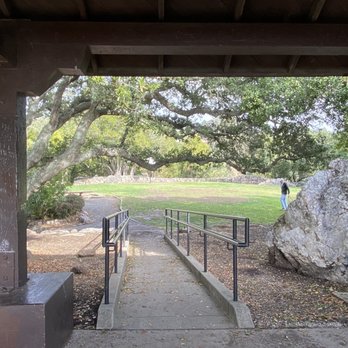 Cragmont Park - Cragmont Park - A park scene viewed from beneath a wooden shelter, featuring a pathway with handrails, large rocks, and trees in the background. - Parks Near Me - Berkeley, California