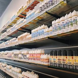 Monster Vape - Product - Ejuice and E-Liquid wall featuring Red Star Juice and premium brands like Juice Head.