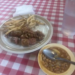 Their chopped brisket, sausage, baked beans, and fries Their chopped brisket, sausage, baked beans, and fries