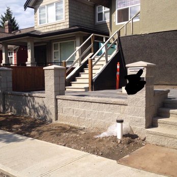 HJL Enterprises - a house with stairs and a fire hydrant - Landscaping Near Me