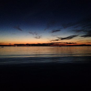 Sand Bar & Grill - a sunset over the ocean - Bars Near Me - Alpena, Michigan