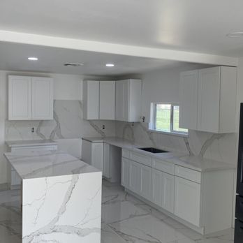 Double G Stone Works - Beautiful calacatta quartz with full height backsplash and waterfall on the island. - Countertop Installation Near Me Double G Stone Works - Beautiful calacatta quartz with full height backsplash and waterfall on the island. - Countertop Installation Near Me