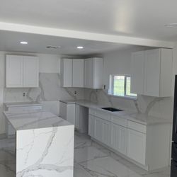Double G Stone Works - Beautiful calacatta quartz with full height backsplash and waterfall on the island.