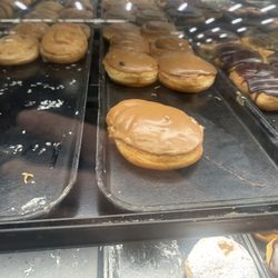 Safeway - The bakery worker did not care about a fly on the doughnuts.