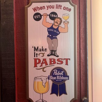Kolb Road Lounge - a man holding a glass of beer - Dive Bars Near Me - Tucson, Arizona