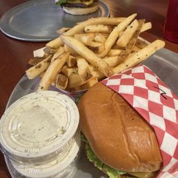 Bison burger; hamburger and two vanilla milkshakes. Bison burger; hamburger and two vanilla milkshakes.