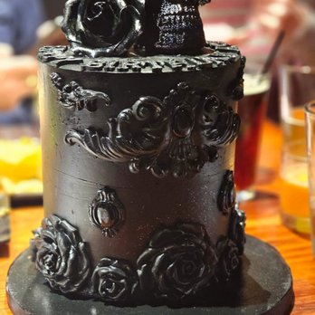 Two Little Monkeys Bakery - a chocolate cake decorated with skulls and roses - Custom Cakes Near Me Two Little Monkeys Bakery - a chocolate cake decorated with skulls and roses - Custom Cakes Near Me