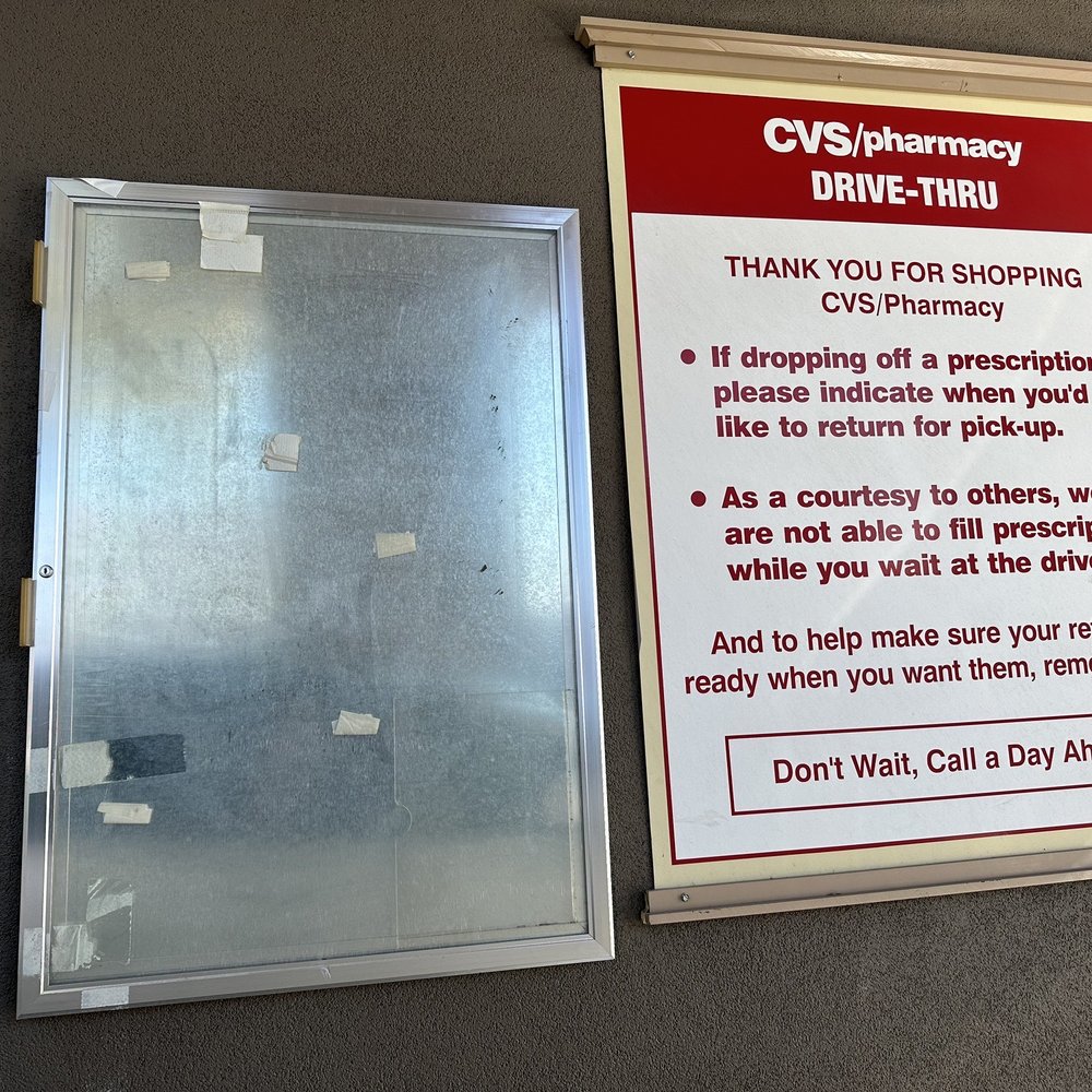 a drive thru window and a sign a drive thru window and a sign