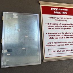 a drive thru window and a sign