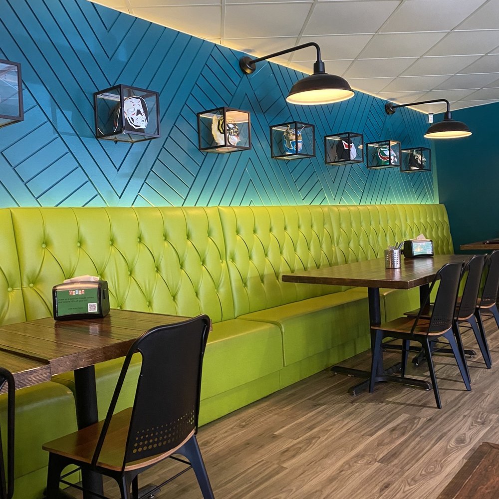 a brightly colored booth with green and blue walls a brightly colored booth with green and blue walls