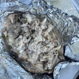 Pork potato with white sauce, I think? Weird combo Pork potato with white sauce, I think? Weird combo