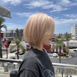 Theodora Hair Studio Olympic - Soft peach blonde color with airy dimension and a fresh layered bob, created by our blonde specialists in Los Angeles.