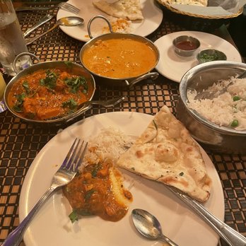 Mughlai Grill - Left Chicken Xacutti, right chicken Kashmir. Naan in the plate. - Indian Near Me - New York, New York Mughlai Grill - Left Chicken Xacutti, right chicken Kashmir. Naan in the plate. - Indian Near Me - New York, New York