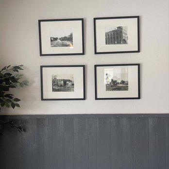 Three 33 - a bench in a room with pictures on the wall - American Near Me - Princeton, Iowa Three 33 - a bench in a room with pictures on the wall - American Near Me - Princeton, Iowa