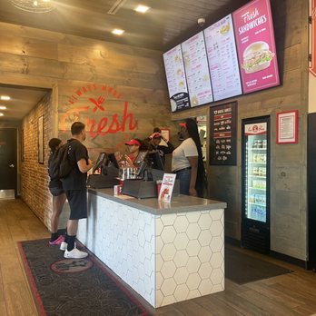 Slim Chickens - Main counter for ordering and pickup. Adequately staffed! - Chicken Shop Near Me - Wesley Chapel, Florida