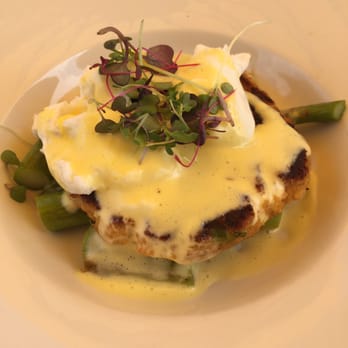 Lake Vista Cafe - Crab Cake Benedict on a bed of asparagus topped with poached egg, lemon hollandaise and micro greens - American Near Me - Madison, Wisconsin Lake Vista Cafe - Crab Cake Benedict on a bed of asparagus topped with poached egg, lemon hollandaise and micro greens - American Near Me - Madison, Wisconsin
