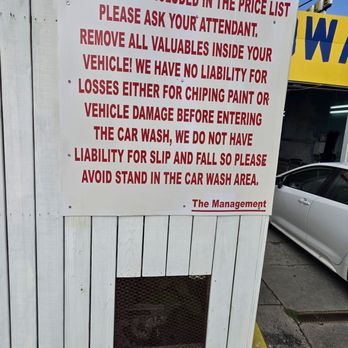 Santos Hand Car Wash - Disclaimer sign. Fairly safe. I haven't heard of anyone complaining about damages or theft. I've been coming here for 5yrs now. - Car Wash Near Me - Marietta, Georgia