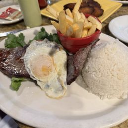 The steak with egg on top and rice and french fries is an excellent dish. The steak with egg on top and rice and french fries is an excellent dish.