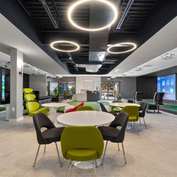 Eagle 5 Golf - Indoor Golf - Our lobby area with a practice green, rest area and bar surrounded by driving range bays and course play bays.