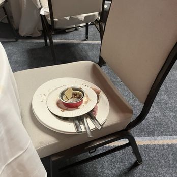 Hotel del Coronado, Curio Collection by Hilton - Plates stacked up on an empty chair where - Coronado, CA