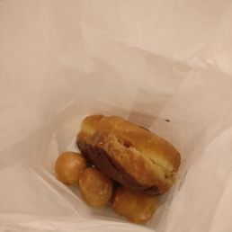 Chocolate custard donut with some donut holes Chocolate custard donut with some donut holes