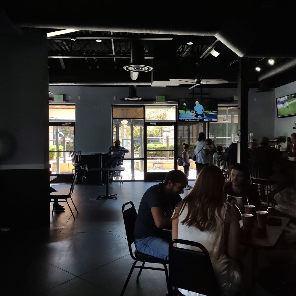Q's Quisine - people sitting at tables in a restaurant - Food Trucks Near Me