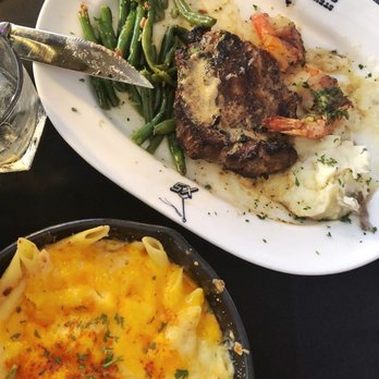 Steiner Ranch Steakhouse - Texan Ribeye 18oz with bacon wrapped shrimp and Lobster Mac & Cheese - Steakhouses Near Me - Austin, Texas