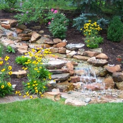 The Garden Kingdom - Stream and pond running through landscaping!