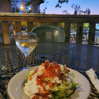 Paddy's Hollow - Wedge salad and wine outdoors. - American Near Me - Wilmington, North Carolina Paddy's Hollow - Wedge salad and wine outdoors. - American Near Me - Wilmington, North Carolina