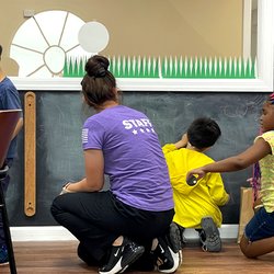 Clairmont Advanced Education Center - Practicing phonics with teacher on the chalkboard