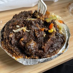 Oxtail, Cabbage and rice and peas , this is a lot (mostly rice) for 21 dollars