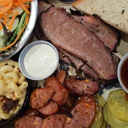 BBQ plate with side salad and Mac, sliced brisket, and jalapeños cheese sausage. BBQ plate with side salad and Mac, sliced brisket, and jalapeños cheese sausage.