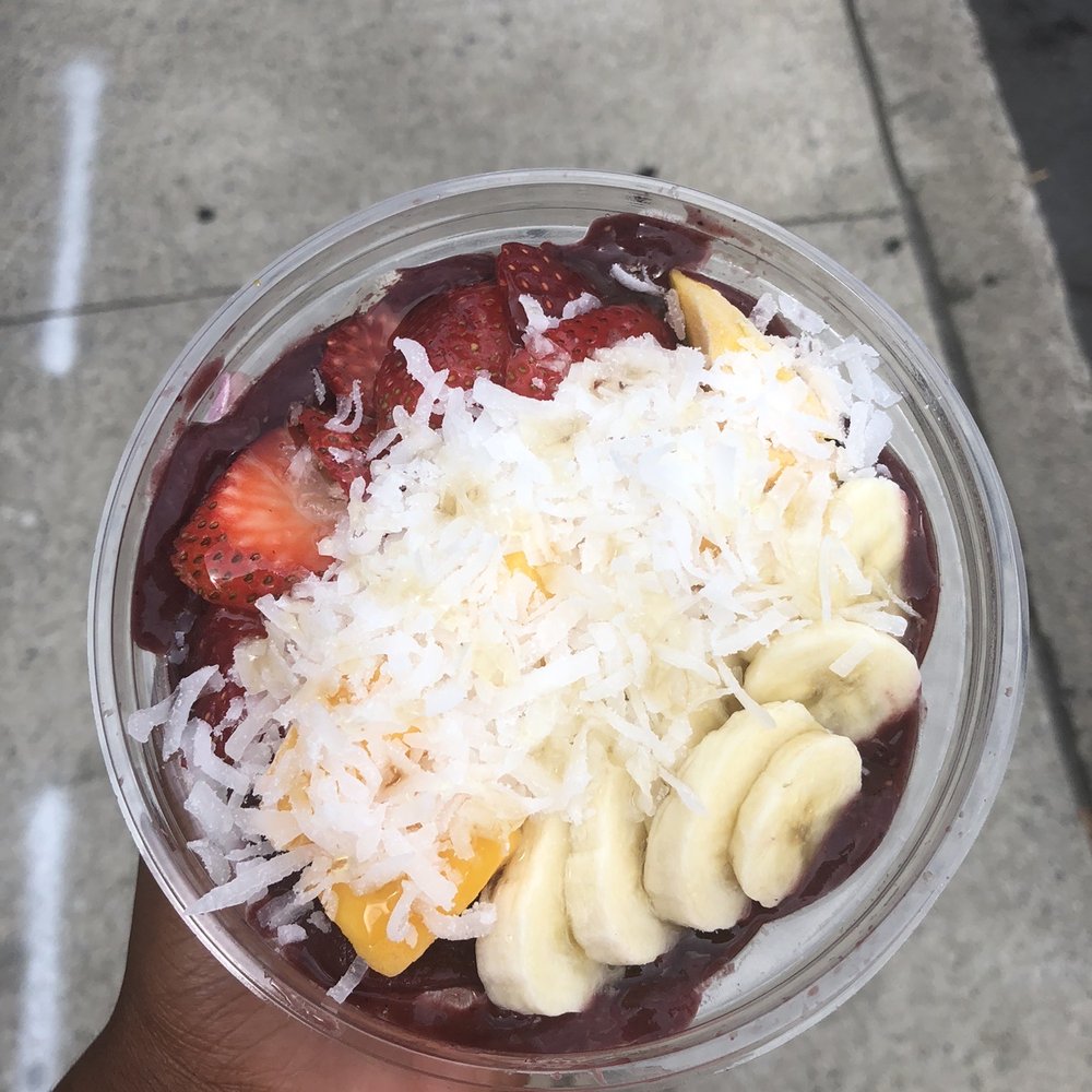 a hand holding a cup of fruit a hand holding a cup of fruit