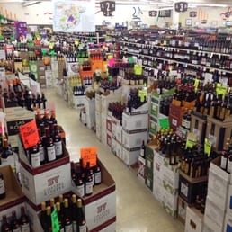 rows of wine bottles in a store rows of wine bottles in a store