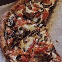Pizza Joe's & Deli - Garlic pizza with mushrooms and tomatoes, brushed in garlic butter and sprinkled with Parmesan cheese.