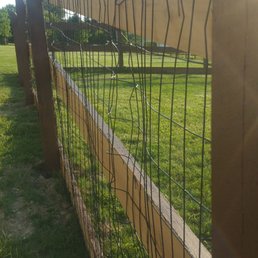 a view of a fence and a field a view of a fence and a field