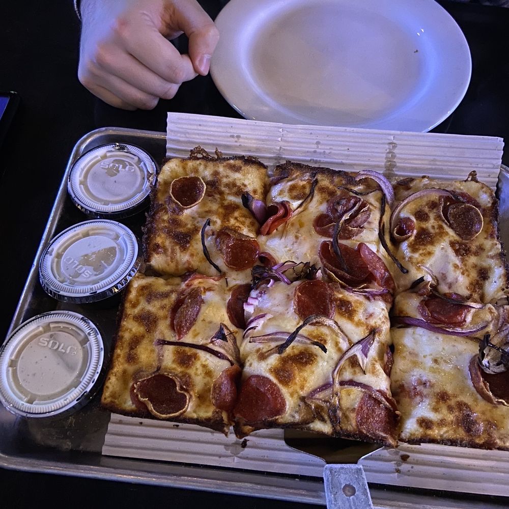 Detroit style pizza with pepperoni, red onions, and garlic crust