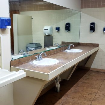 bp - a public restroom with two sinks and a large mirror - Gas Stations Near Me - Forsyth, Georgia