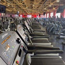 Powerhouse Gym Linden - The photo shows the cardio training section at our Linden fitness center. Rows of Life Fitness treadmills, ellipticals, & Sta...
