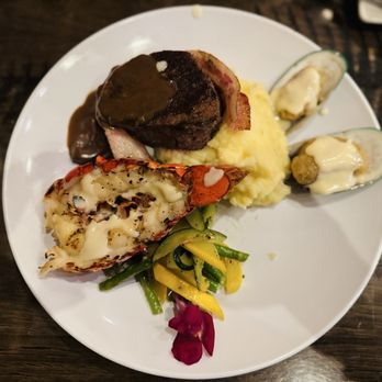 Lakeside Lodge - Filet wrapped in bacon, lobster tail, mussels, fresh veggies and Yukon whipped potatoes. - Bars Near Me - Island Park, Idaho Lakeside Lodge - Filet wrapped in bacon, lobster tail, mussels, fresh veggies and Yukon whipped potatoes. - Bars Near Me - Island Park, Idaho