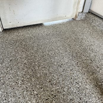 Epoxy Masters - Jose and his team did a grata job around the edges, covering the concrete foundation berm and beneath the side door. - Flooring Near Me