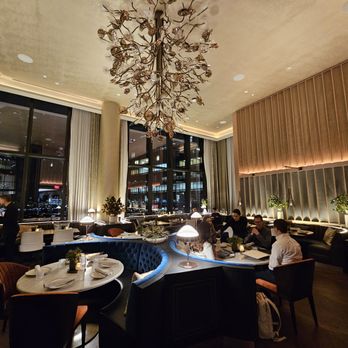 Amar -  dining room with a chandelier and a view of the city - Portuguese Near Me - Boston, Massachusetts