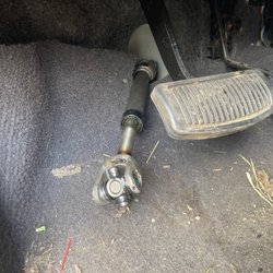 Tire Choice Auto Service Centers - The bottom of the intermediate steering shaft sticking out from behind the brake pedal.
