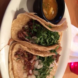 three tacos on a white plate three tacos on a white plate