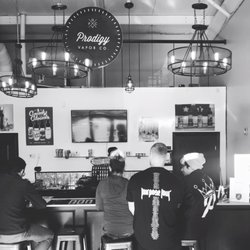 Prodigy Vapor Company - Justin and Chris helping out a customer with their first purchase.