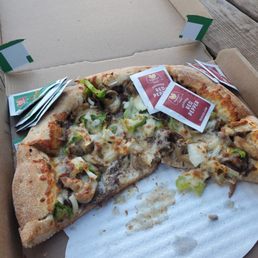 a half eaten pizza in a box